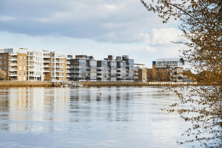 Four London penthouse buildings on the side of the River Thames.